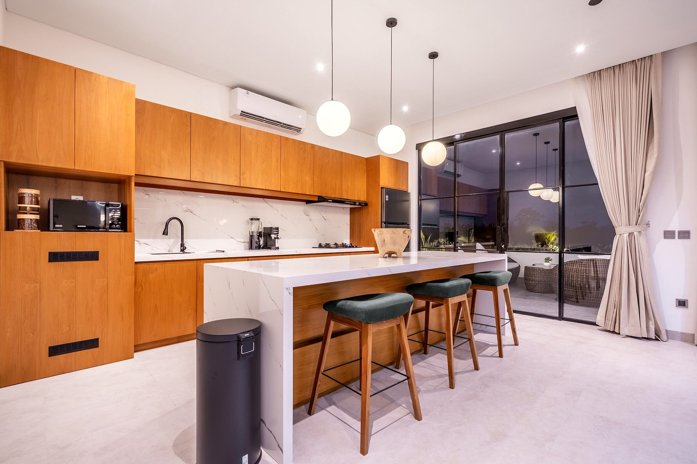 Villa Rice One kitchen with natural wood and marble finishes