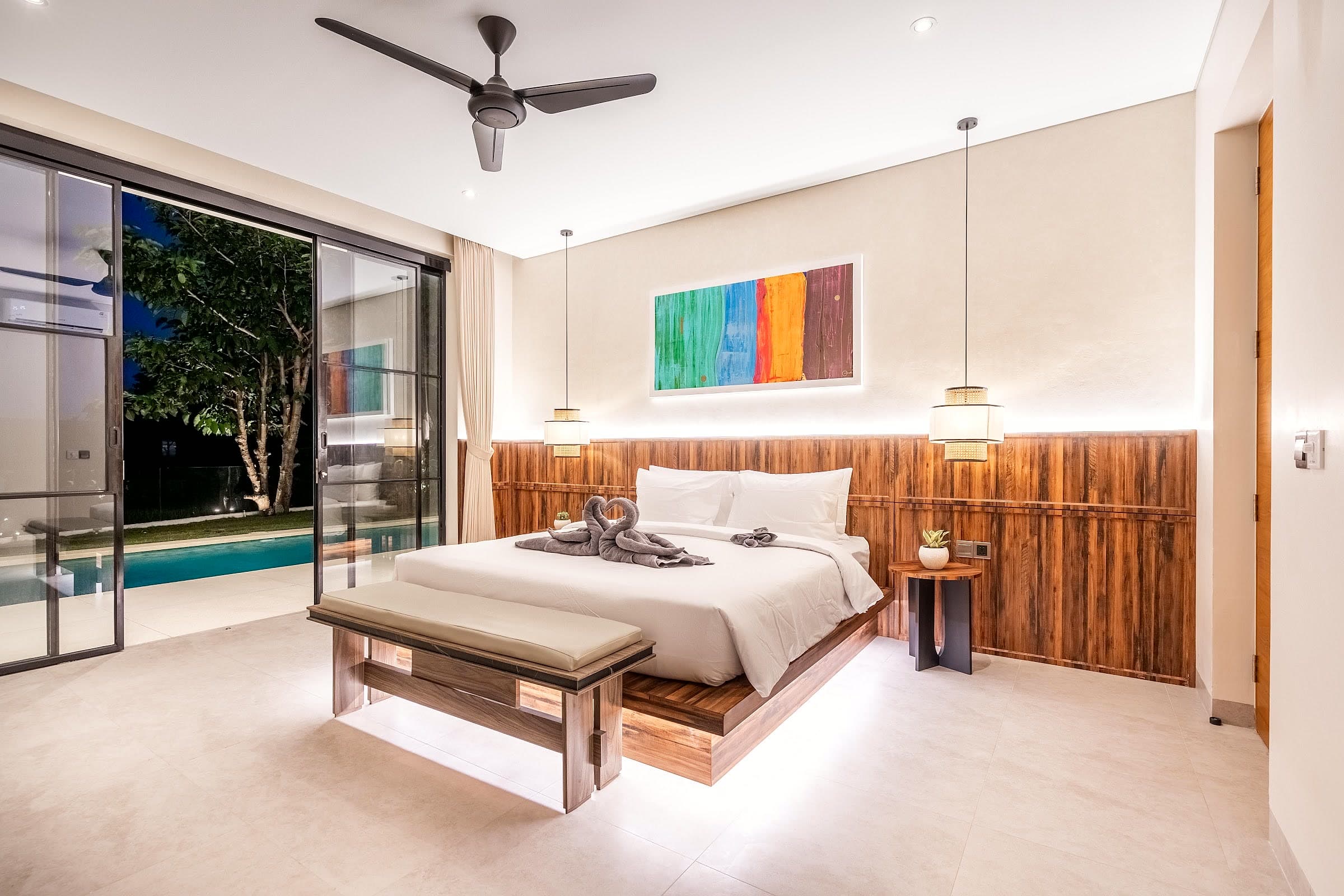 Villa Rice One master suite at night opening onto the pool