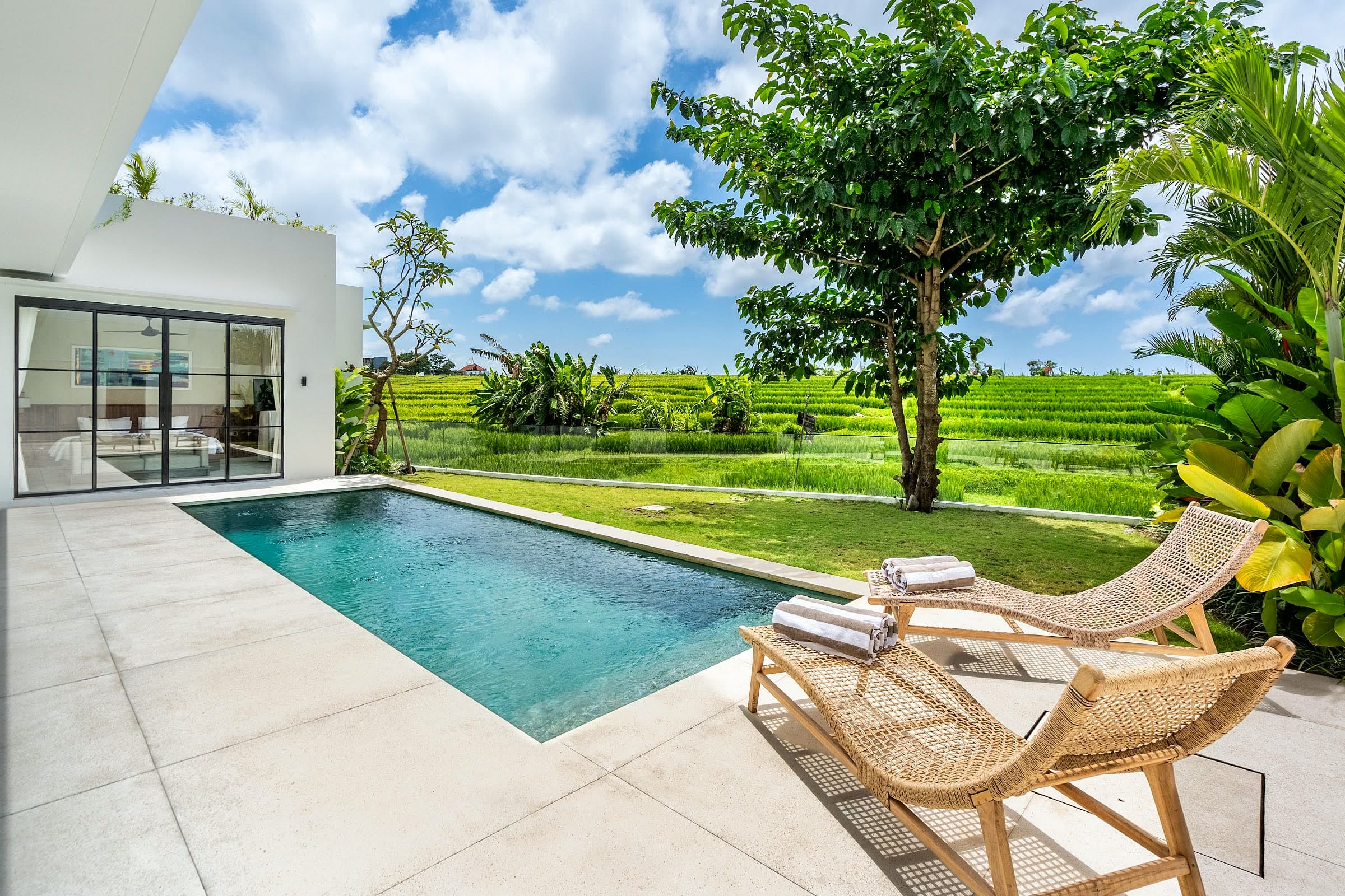 Villa Rice One exterior and pool by day with the rice field beyond